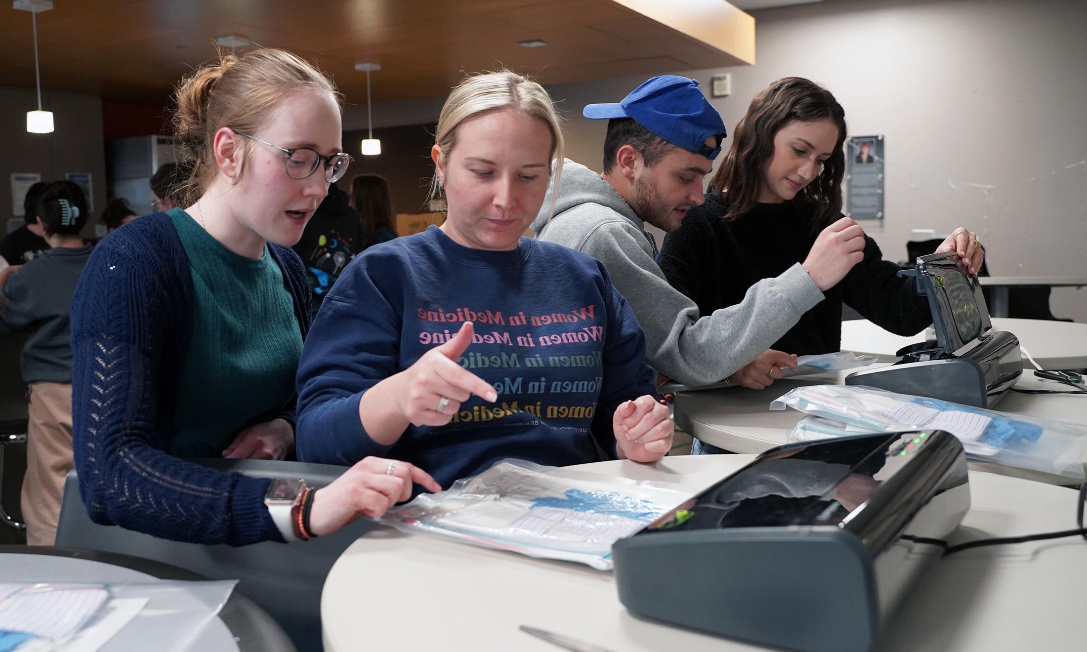 An image of students assembling birthing kits