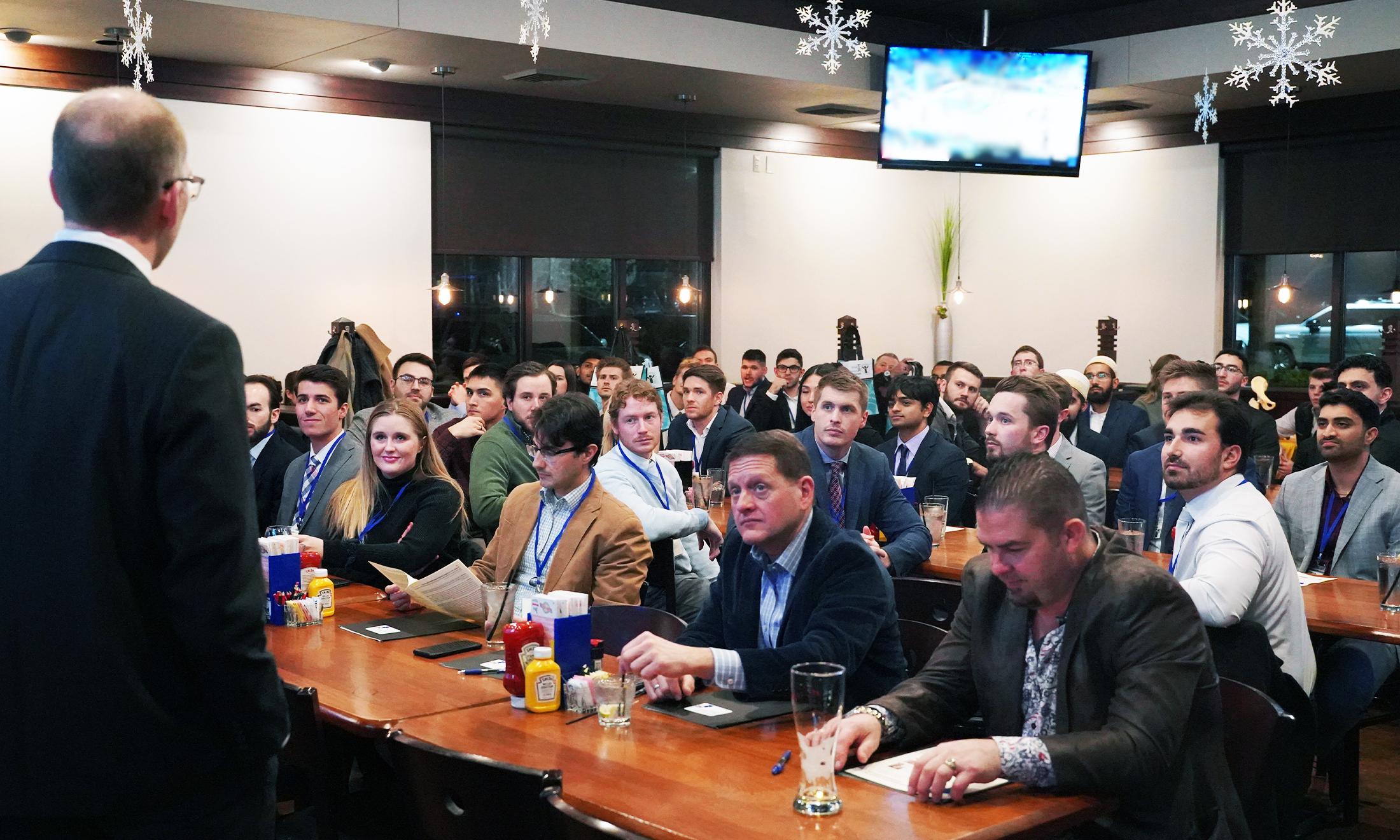 An image of attendees of the conference listening to Dr. Moore