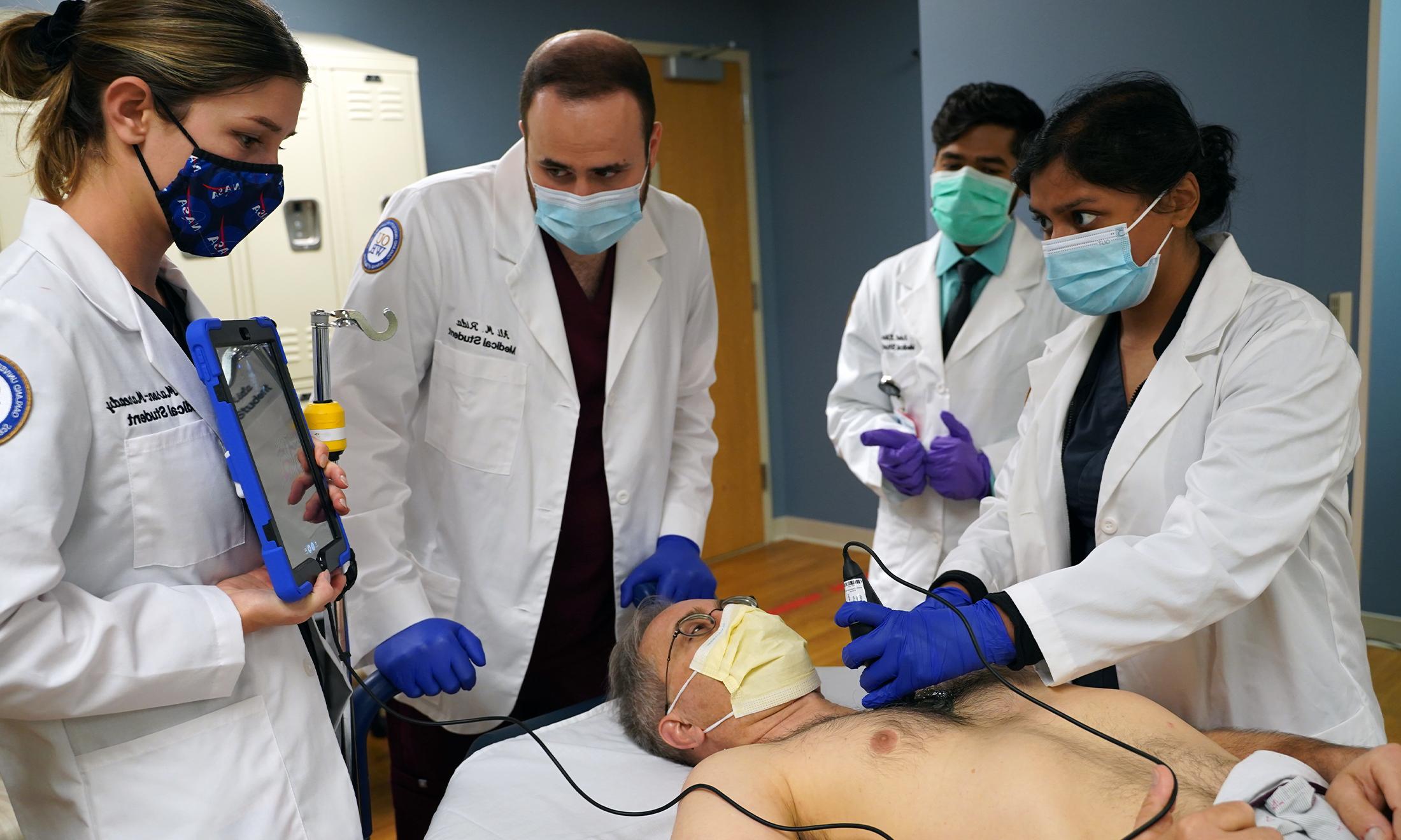 An image of OUWB students using handheld ultrasound.