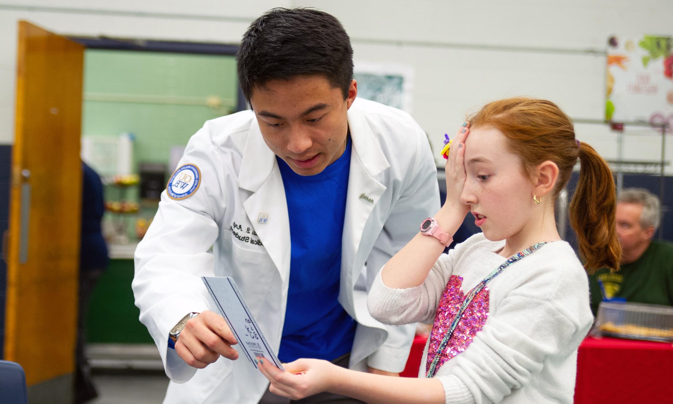 An image of a medical student at a community health fair